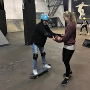 Foto von Azra auf dem Skateboard mit Frau Hölscher (vergrößerte Bildansicht wird geöffnet)
