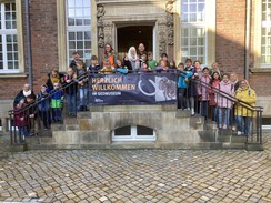 Foto der Schüler:innen und Begleitpersonen auf der Treppe zum Eingang des Geomuseums