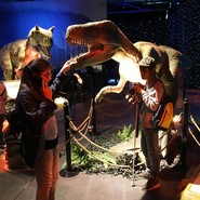 Foto von Azra und Arshat mit einem fleischfressenden Dino (vergrößerte Bildansicht wird geöffnet)